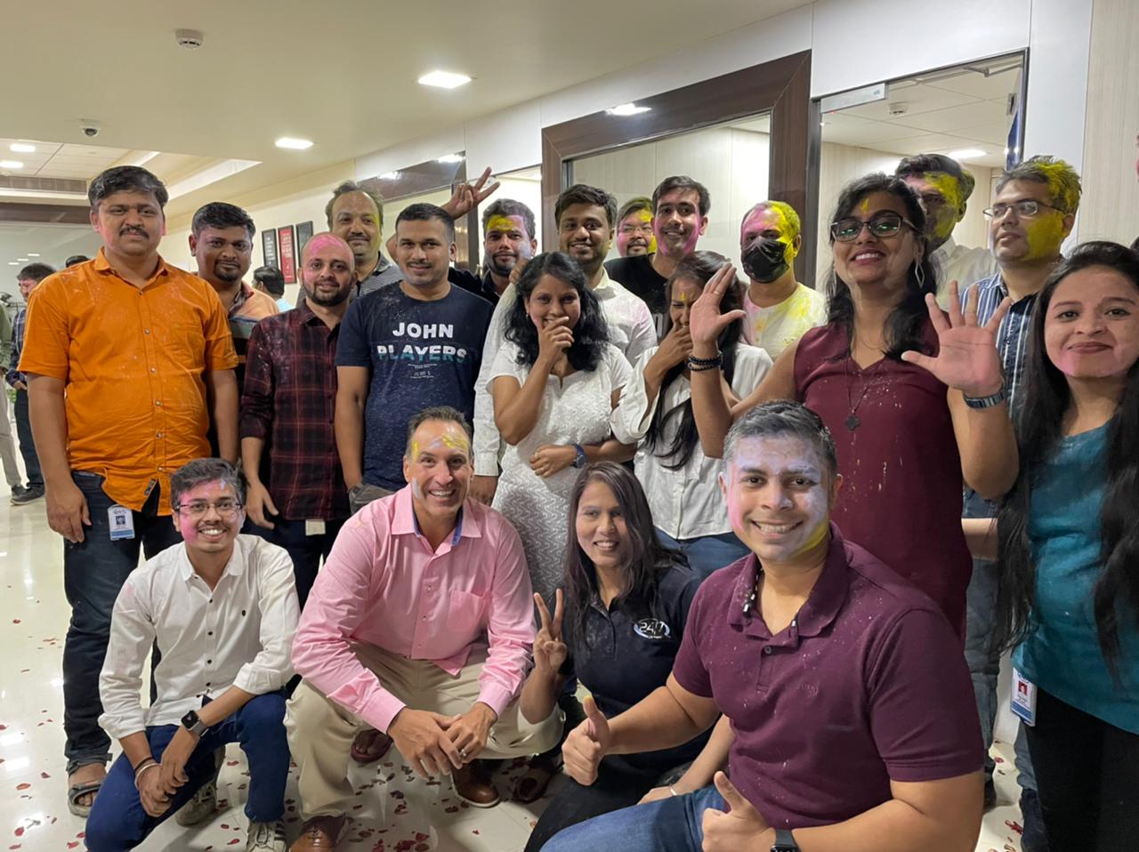 Group photo of 24/7 employees in office